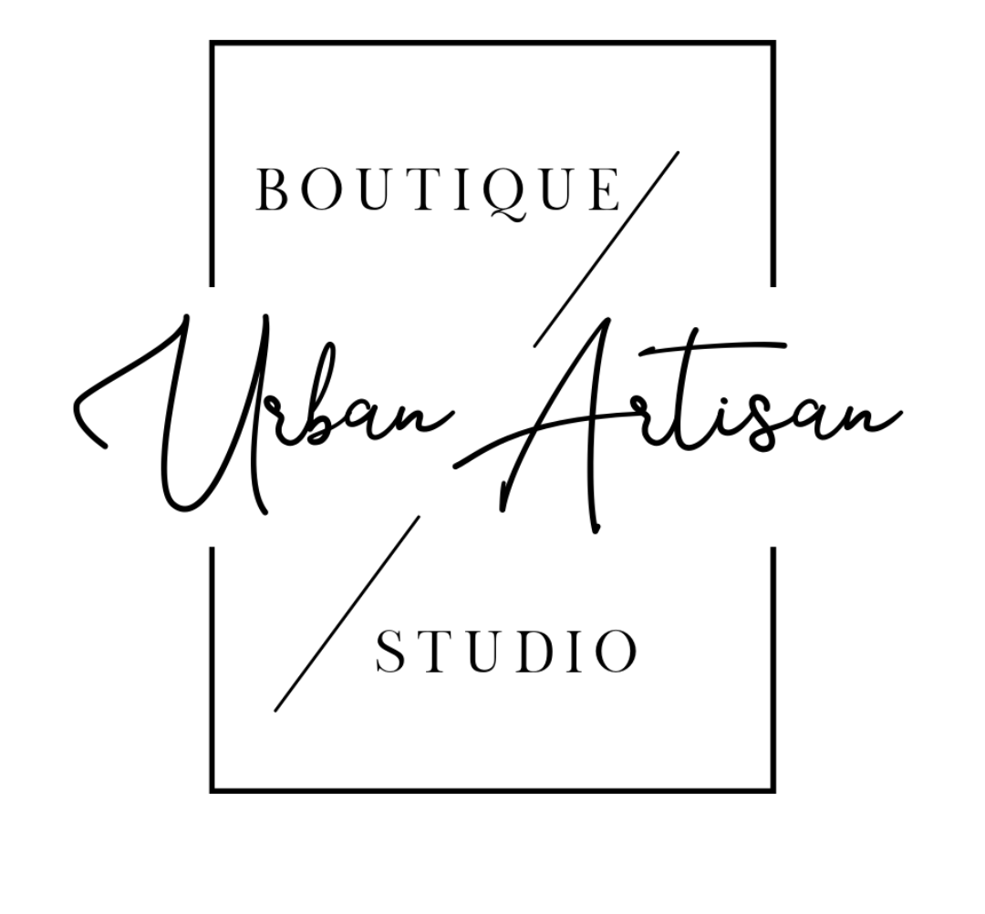 A black and white logo for a boutique called urban artisan studio.