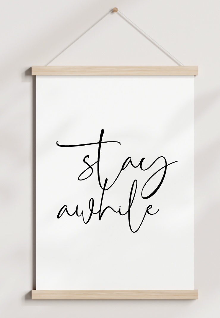 A poster hanging on a wall that says stay awhile