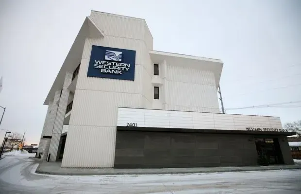 A white building with a blue sign that says Western Security Bank