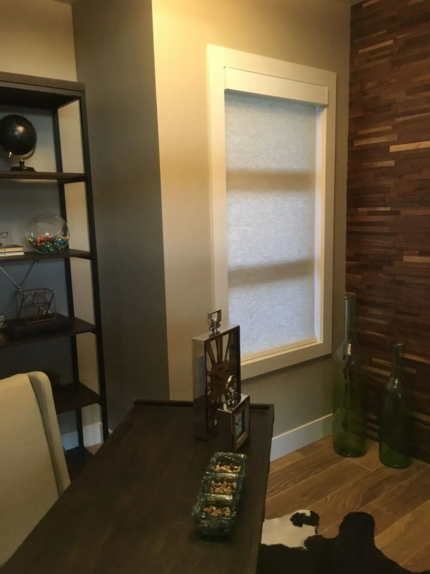 A dining room with a table and chairs and a window