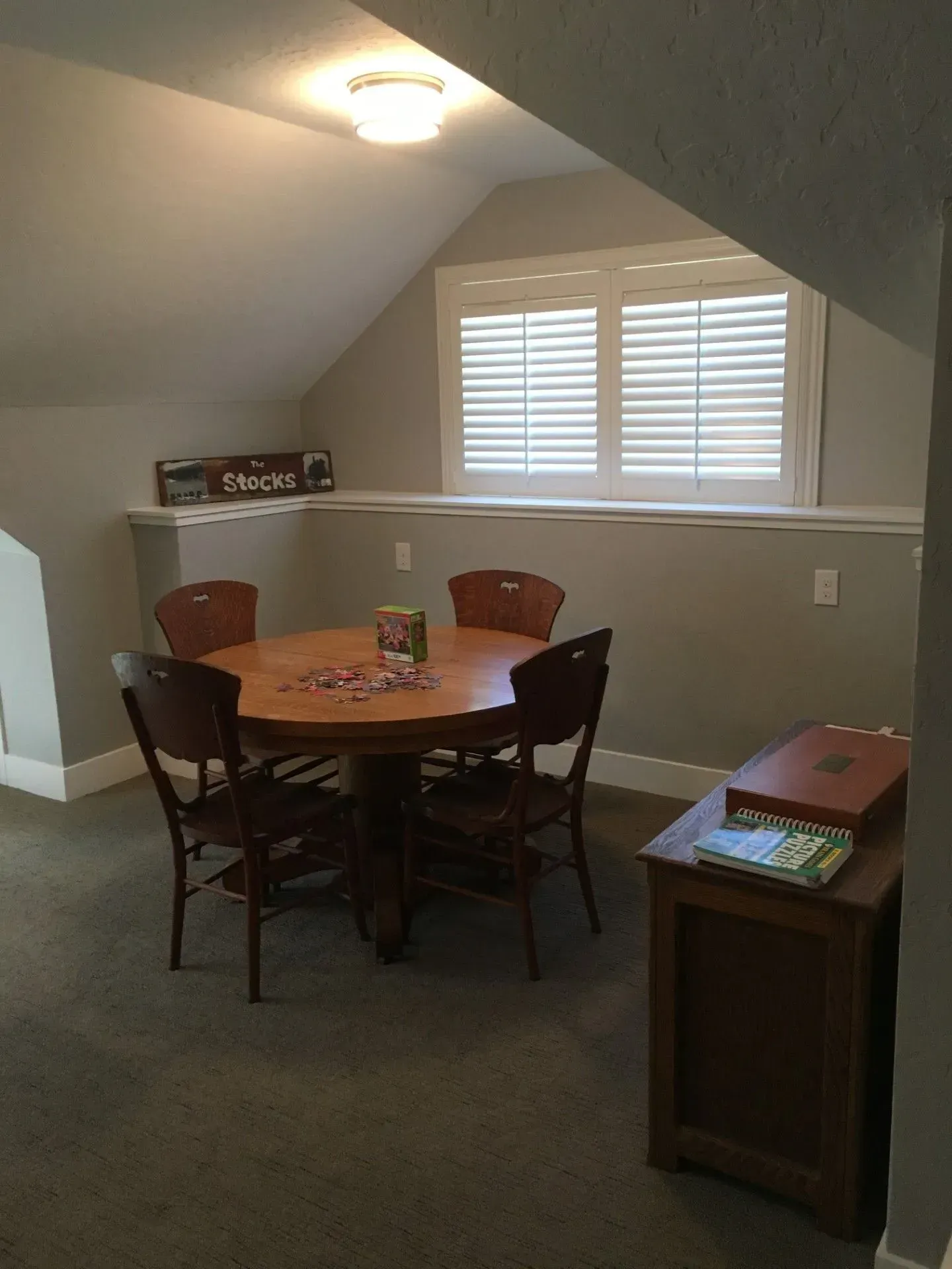 A room with a table and chairs in it