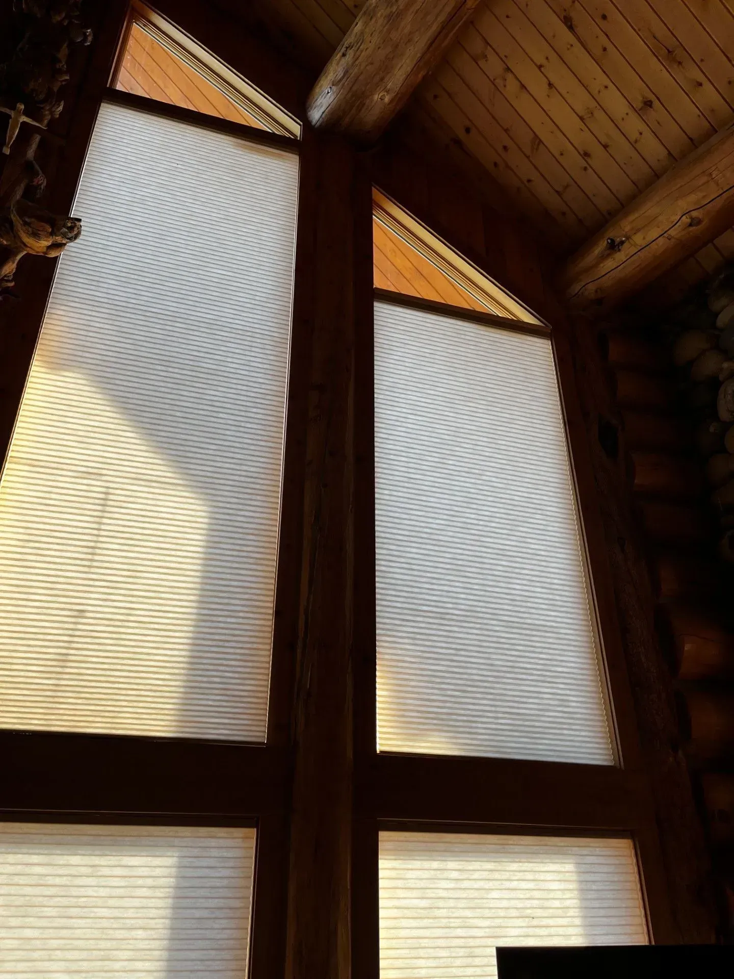 A large window with honeycomb blinds on it