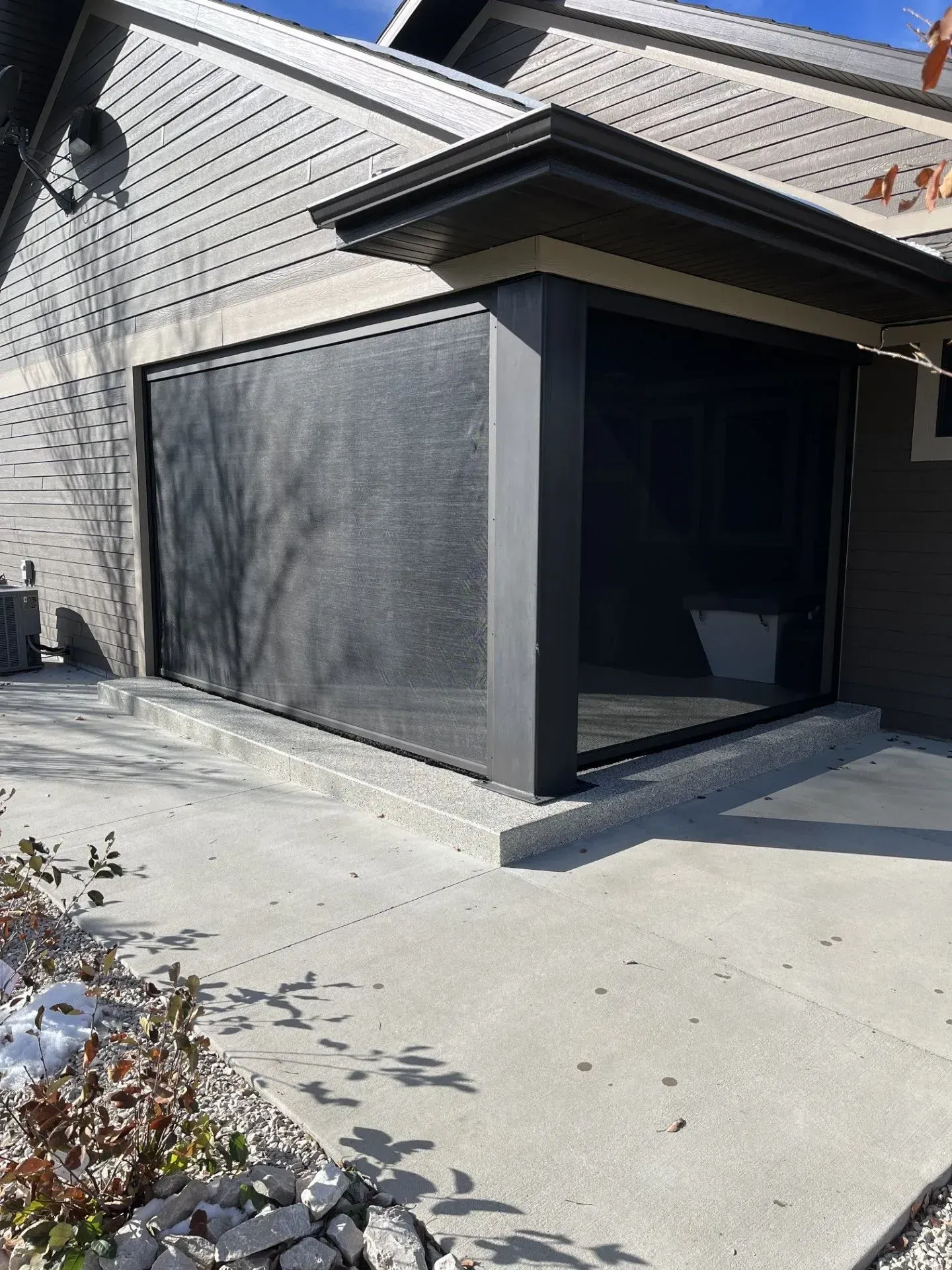 A house with a screen door on the side of it.