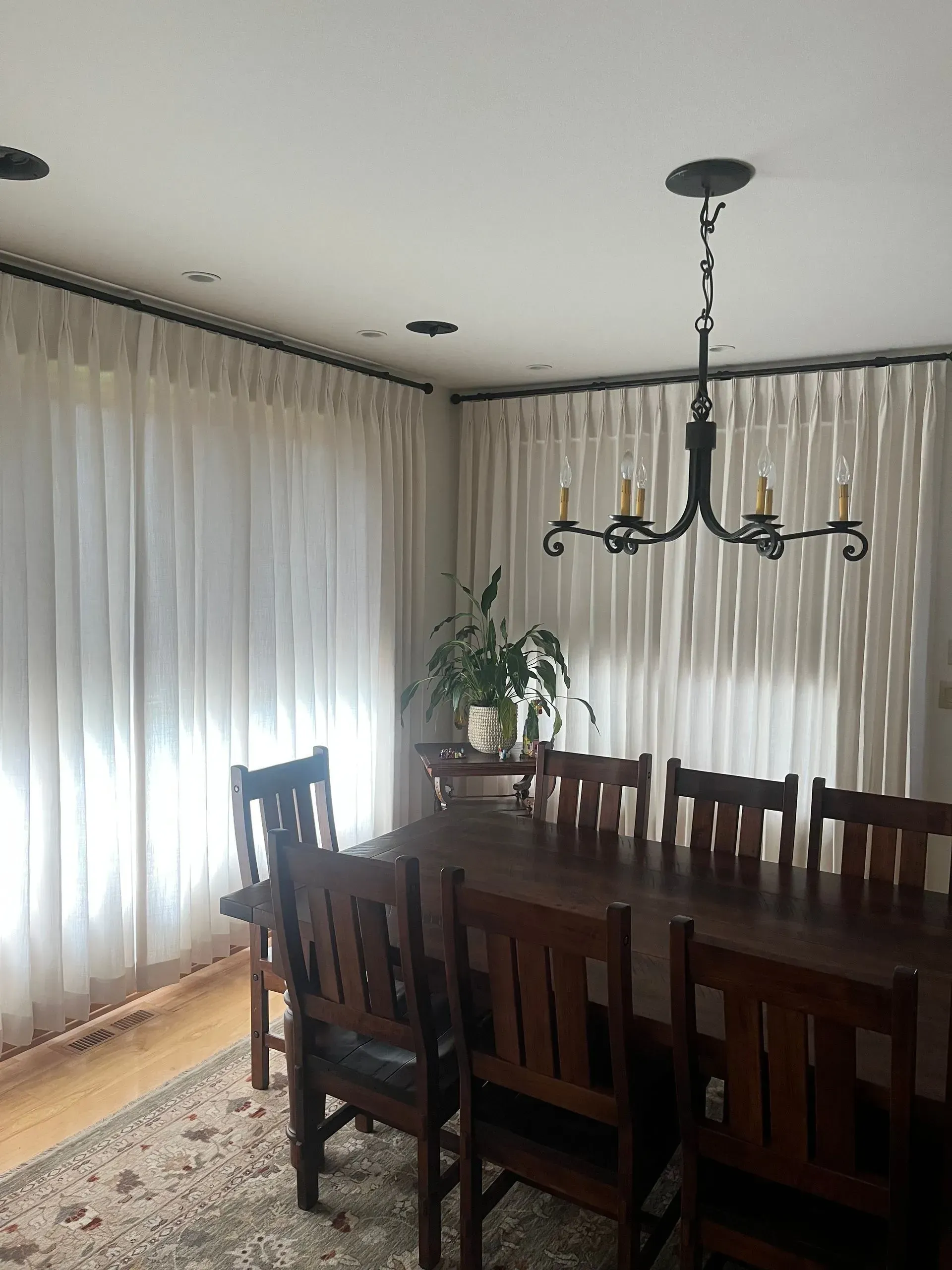 A dining room with a table and chairs and a chandelier