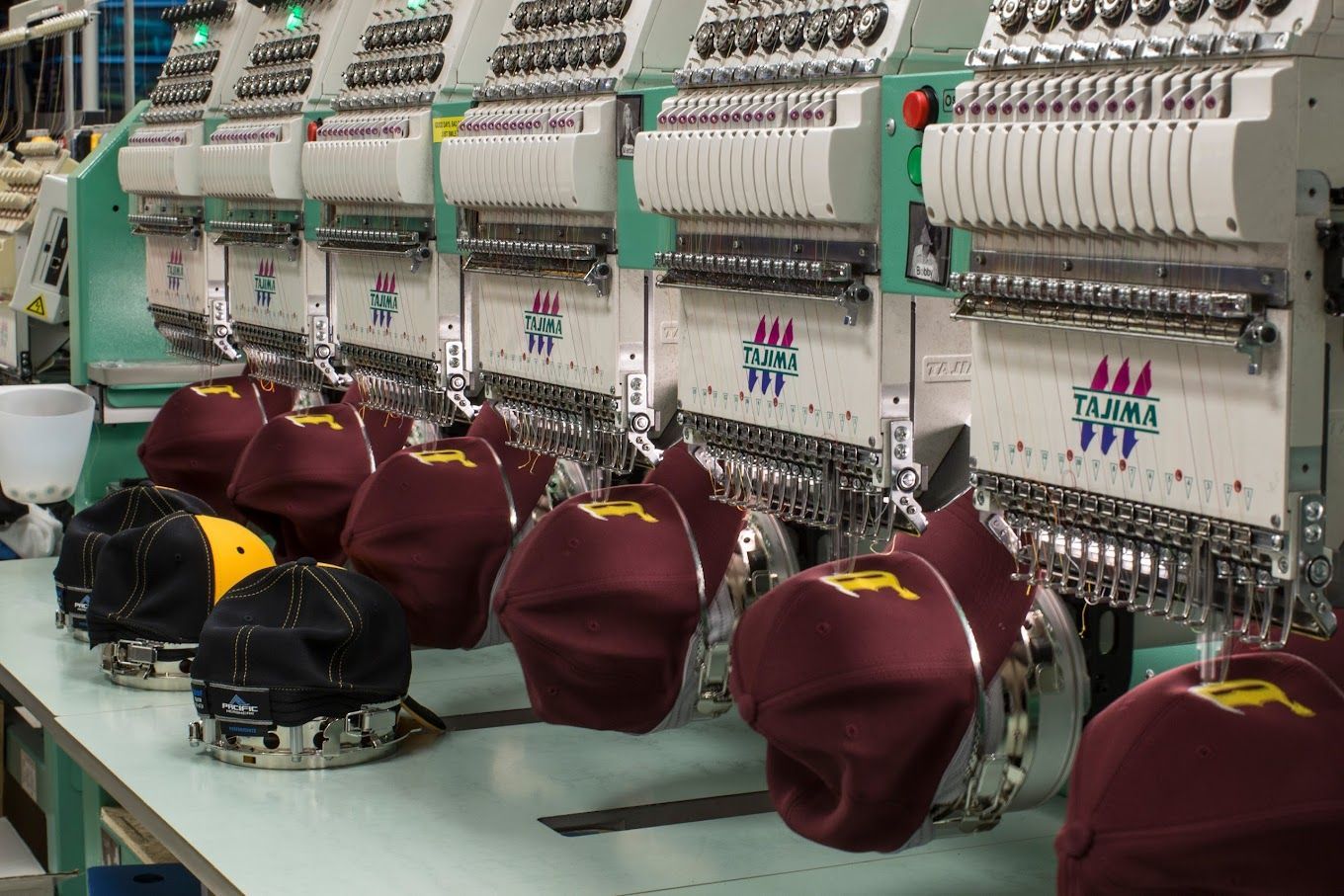 Maroon Hats being Embroidered — Tempe, AZ — Big Stitch Embroidery