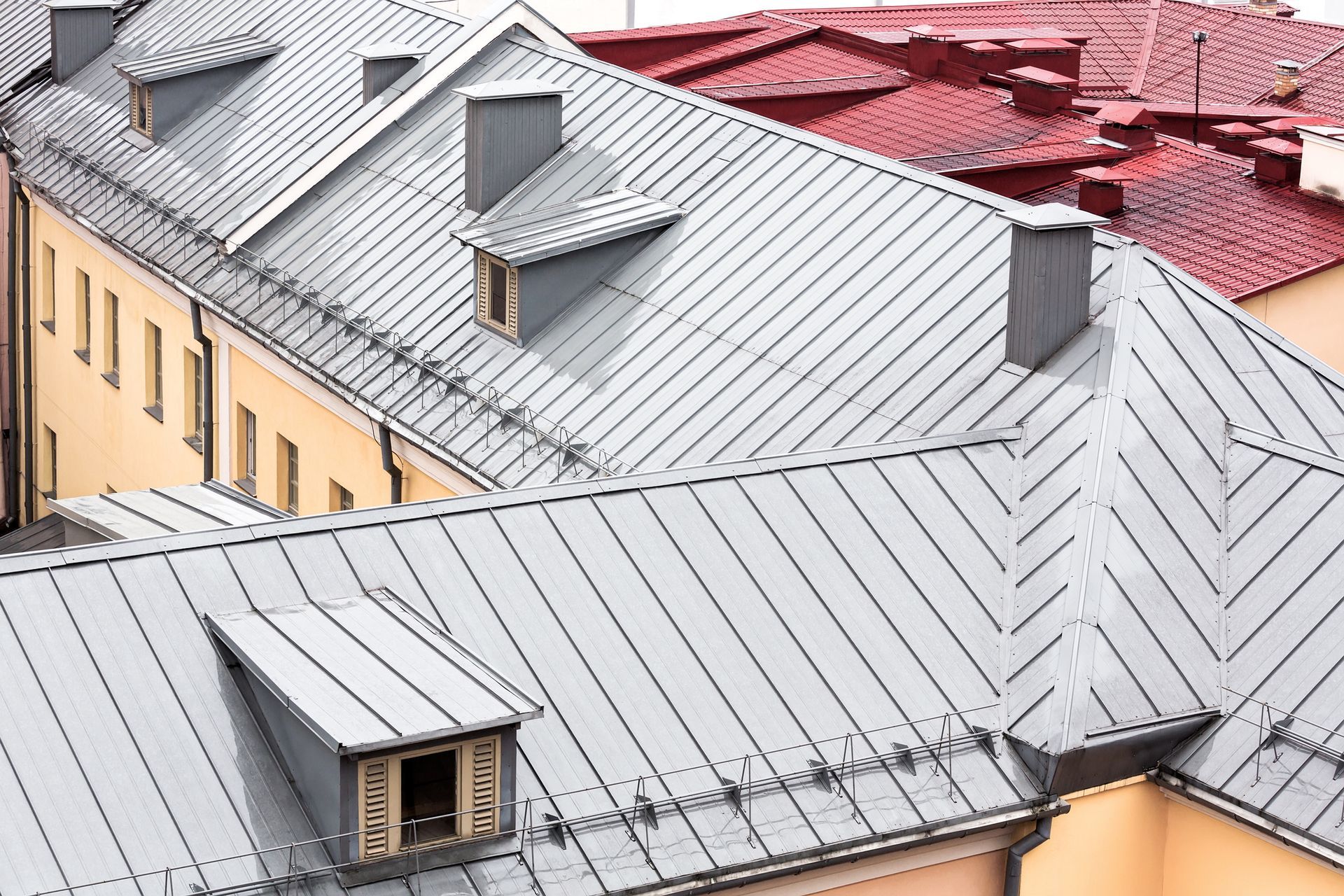 Modern gray metal roof showcasing craftsmanship of a commercial roofing contractor. Modern gray metal roof showcasing craftsmanship of a commercial roofing contractor.