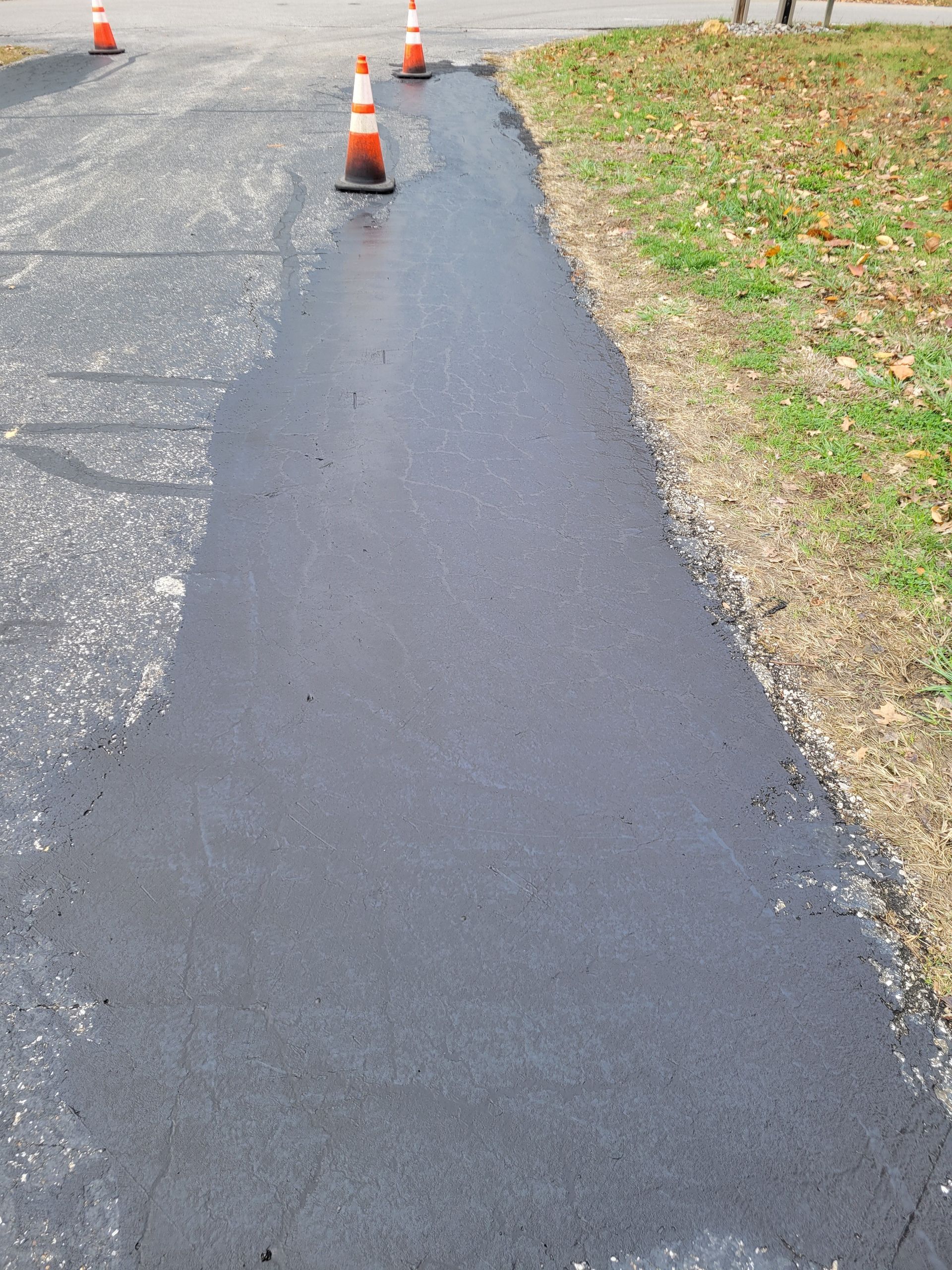 A roller is sitting on top of a pile of asphalt.