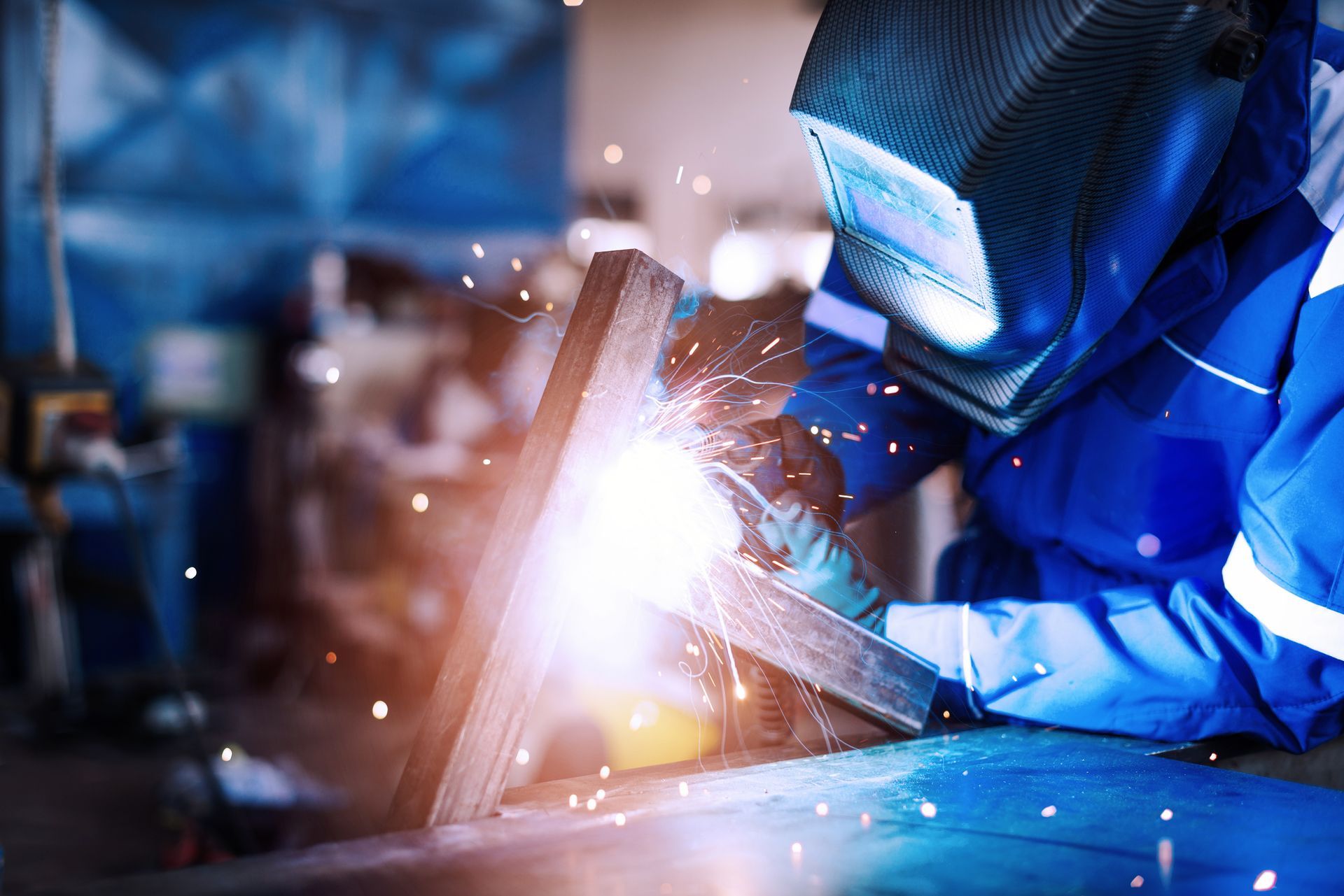 Professional Welder In A Factory Welding Steel Bars — Liberal, KS — Myriad Machine Company Professional Welder In A Factory Welding Steel Bars — Liberal, KS — Myriad Machine Company