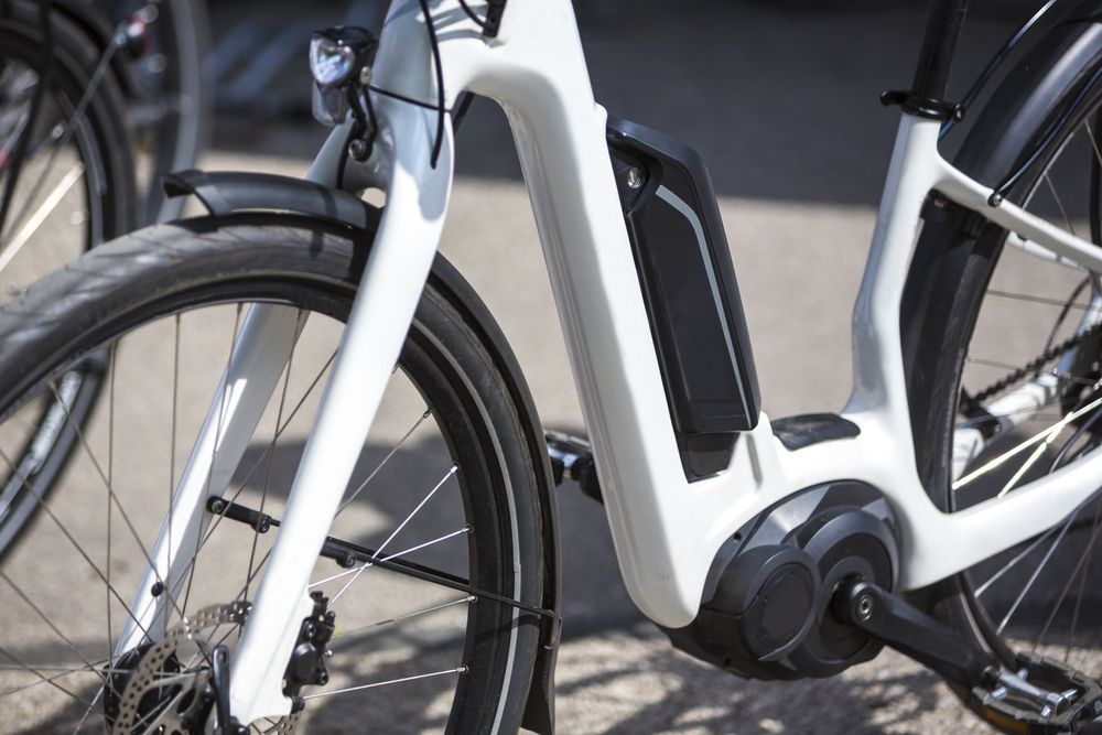 White Electric Bike With Black Battery, Front Wheel, and Motor — SPW Engineering & Powdercoating In Ballarat, VIC