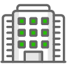 An icon of a large building with green squares on it.