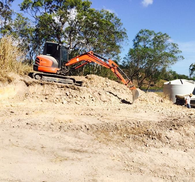 Two Bulldozers Are Sitting on Top of a Pile of Rocks — Eddy’s Excavations & Bobcat Hire In Gladstone, QLD