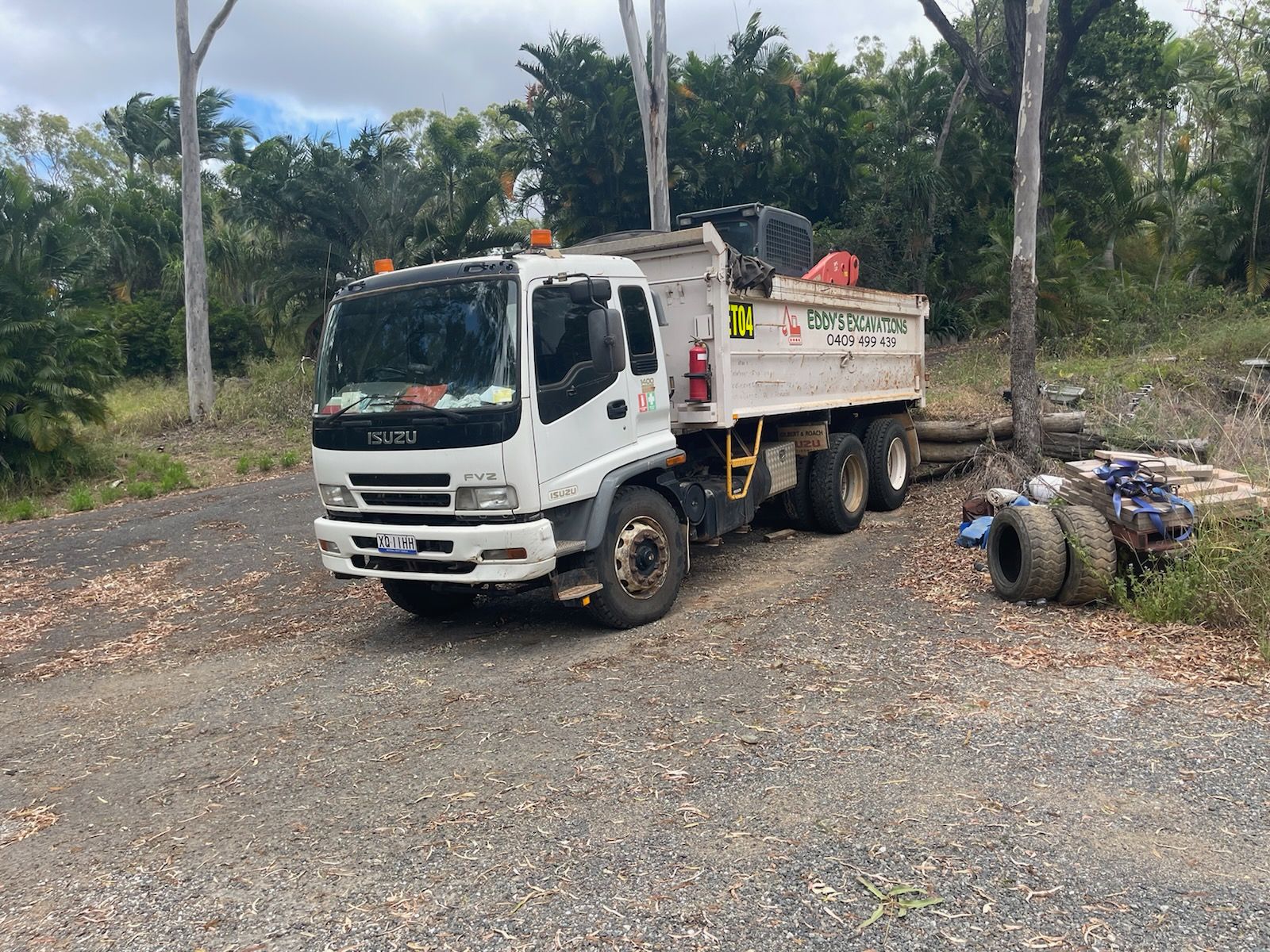 Skid Steer Loader With a Large Bucket is Parked on a Dirt Road — Eddy’s Excavations & Bobcat Hire In Wurdong Heights, QLD