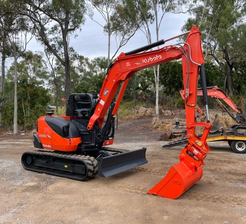 A Yellow and Black Excavator is Moving Dirt on a Construction Site — Eddy’s Excavations & Bobcat Hire In Wurdong Heights, QLD
