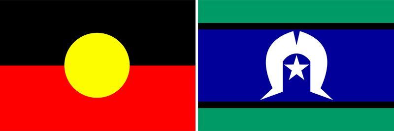Two flags , one red and yellow and one blue and green , are next to each other.