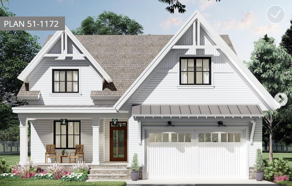 White two-story house with a gabled roof, black window frames, and a garage.