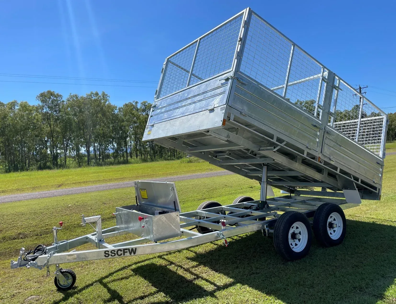 Dump Trailer with Raised Steel Bed and Mesh Sides on A Sunny Grassy Field — SSCFW Trailers In Mareeba, QLD
