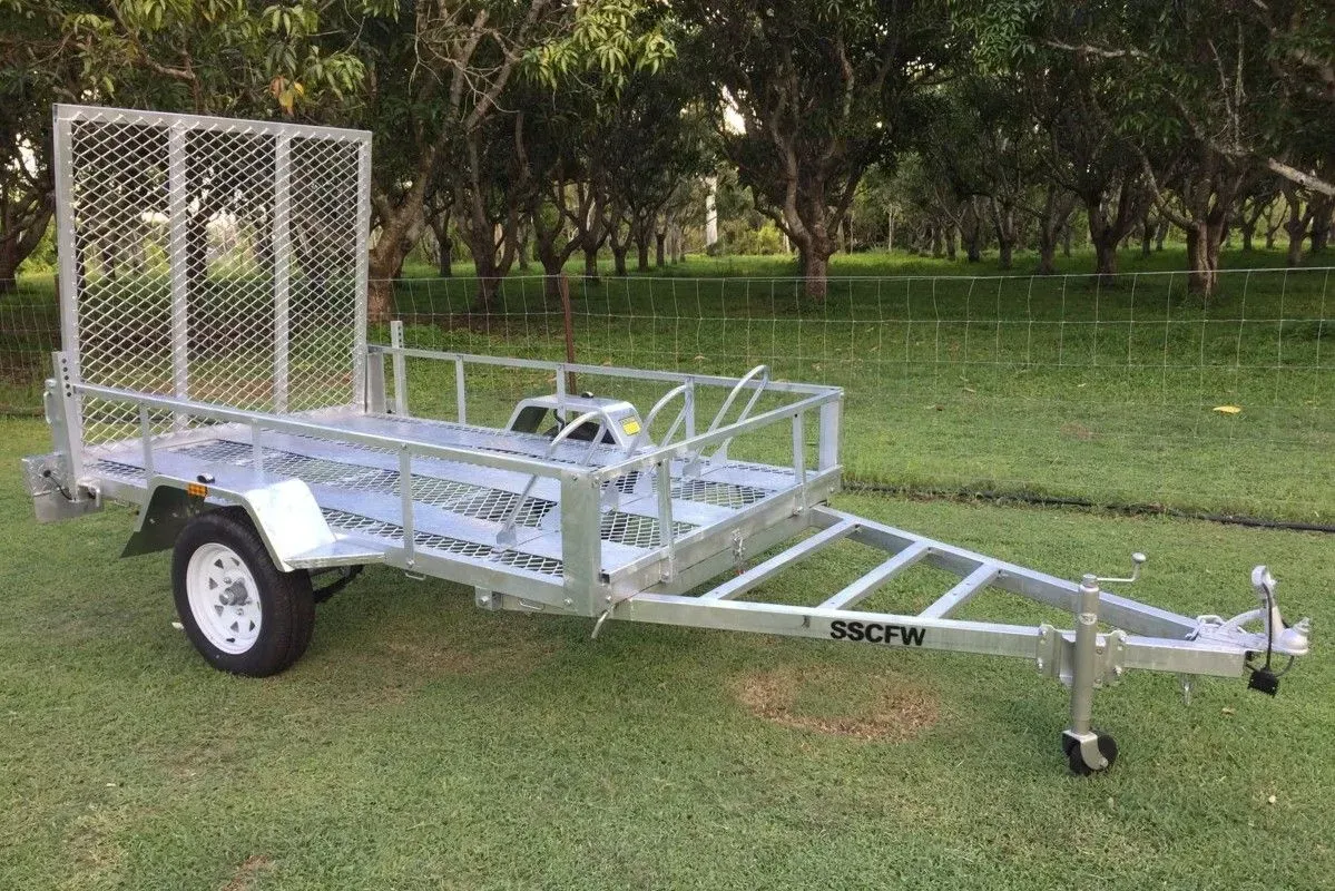Small White Utility Trailer Parked on Grass with Mesh Sides — SSCFW Trailers In Mareeba, QLD