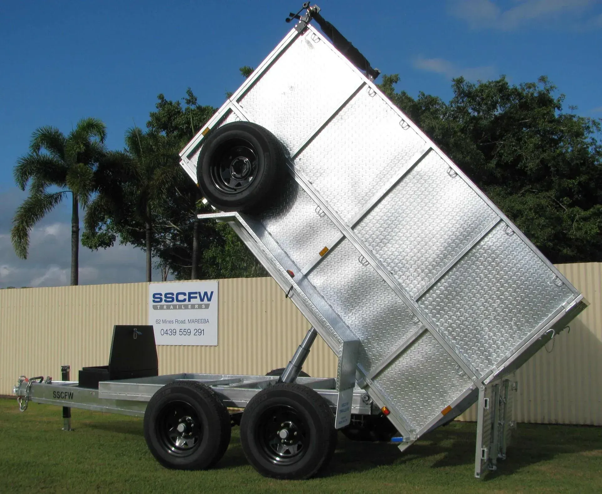 Dump Trailer Bed Raised Steeply on A Black Trailer Under a Blue Sky — SSCFW Trailers In Mareeba, QLD