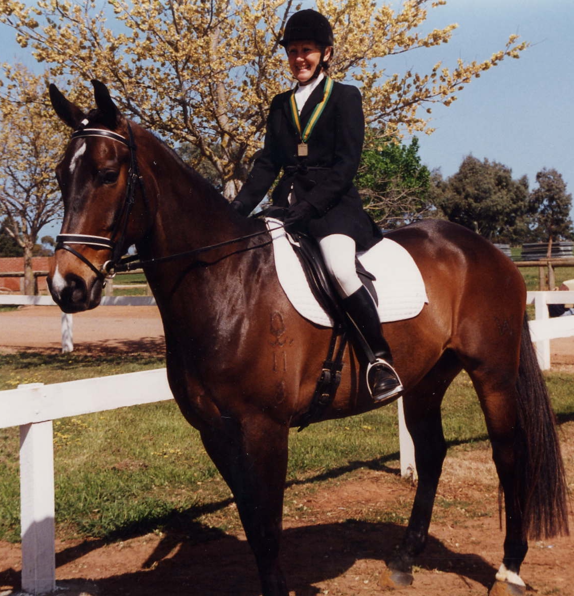 A Woman Wearing a Medal is Riding a Brown Horse — Merrypark Equestrian Centre In Eumundi, QLD