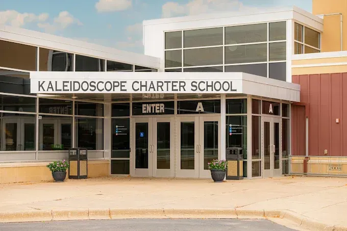 Front entrance of Kaleidoscope Charter School with glass doors and tan exterior walls