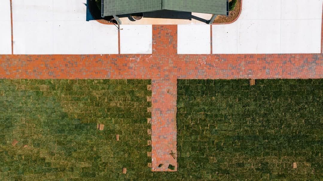 Overhead view of a house with a brick walkway and lawn.