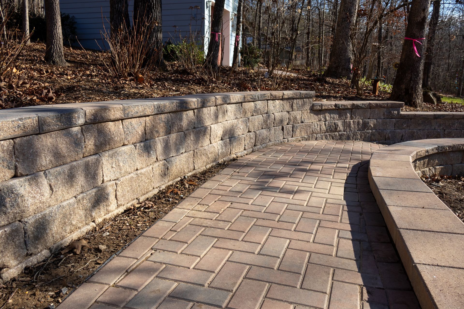 Brick pathway and retaining walls in an outdoor setting.