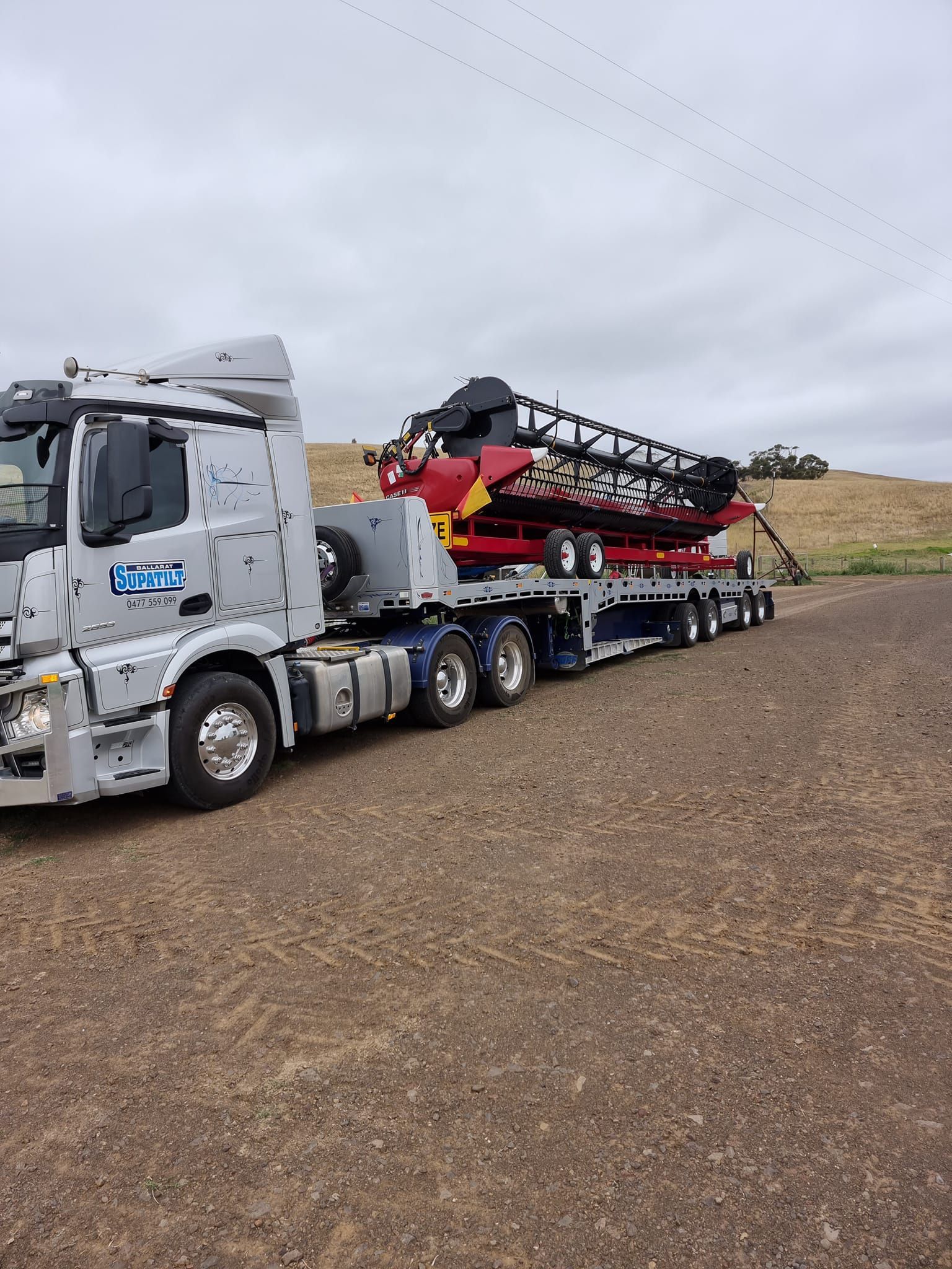 Truck Transporting Large Red Vehicle — Ballarat Supatilt in Delacombe, VIC