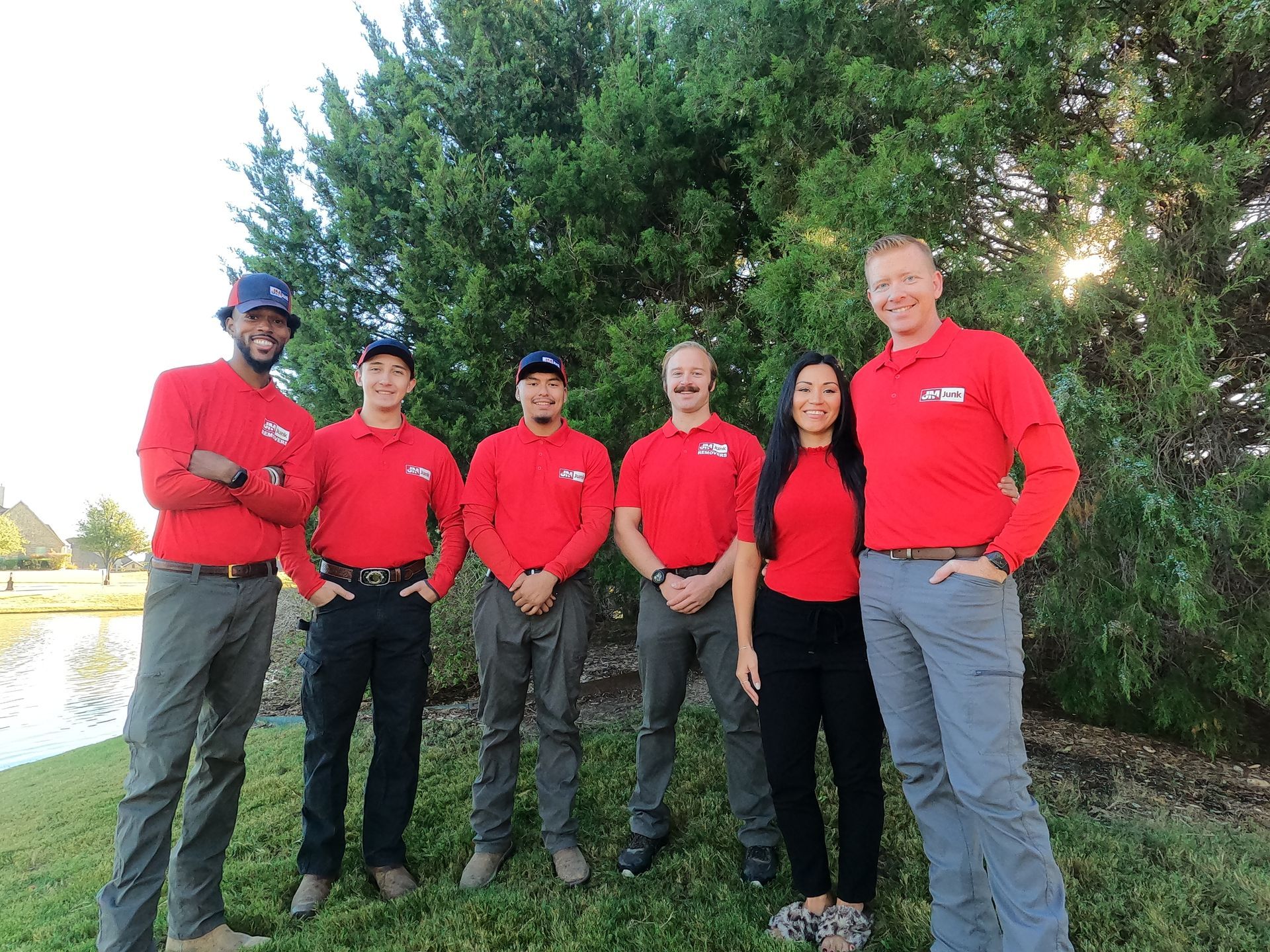 A group of people in red shirts are posing for a picture.