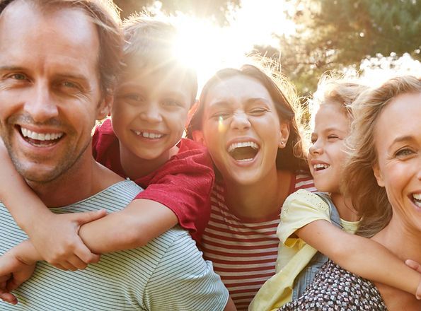 A family is posing for a picture together and smiling.