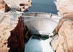 an aerial view of a dam surrounded by rocks and water .