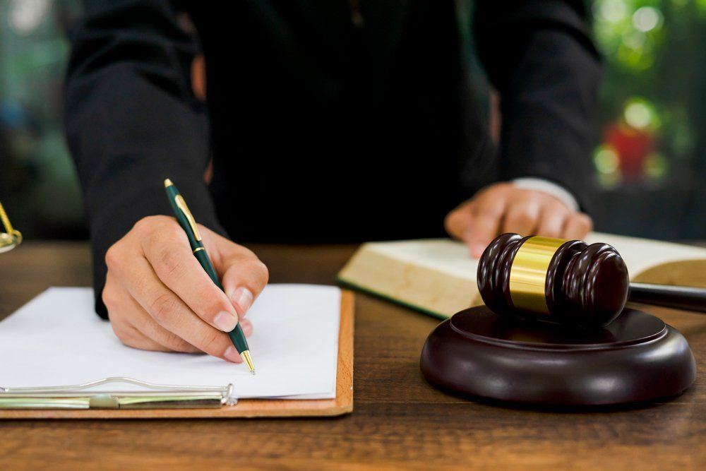 Attorney Writing On A Paper — Gibsonville, NC — Walker & Bullard PA Attorney Writing On A Paper — Gibsonville, NC — Walker & Bullard PA