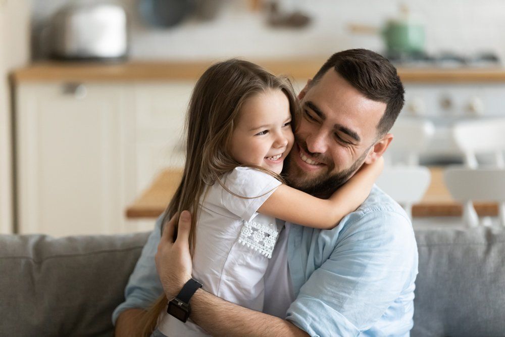 Man Hugging His Daughter — Gibsonville, NC — Walker & Bullard PA Man Hugging His Daughter — Gibsonville, NC — Walker & Bullard PA