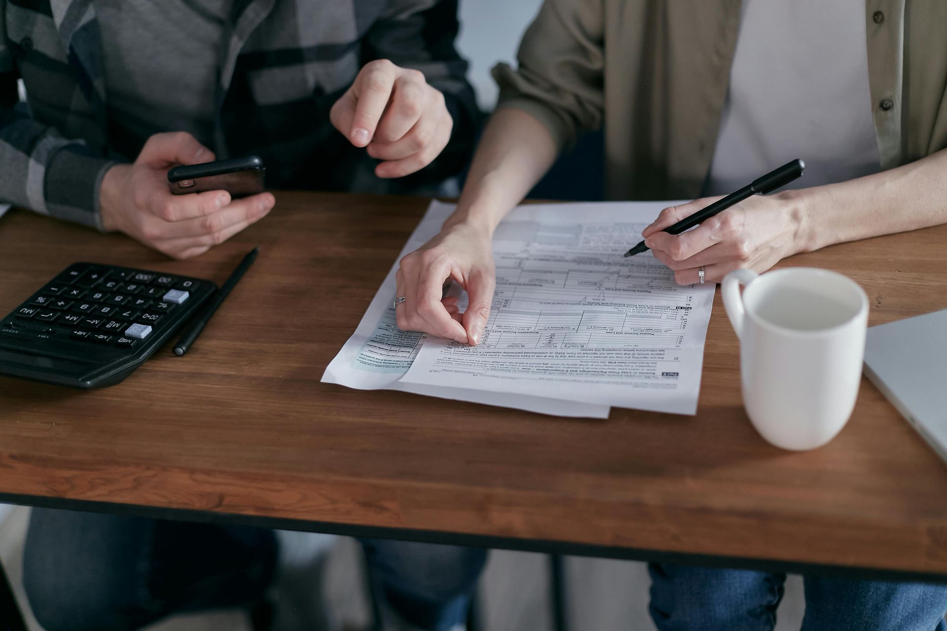 Self-employed borrower discussing bank statement mortgage options with lender