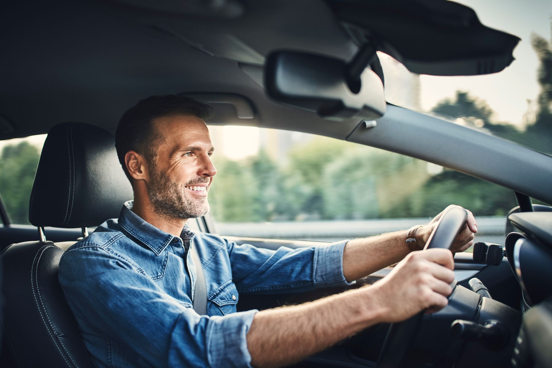 Man smiling while driving a car. Man smiling while driving a car.