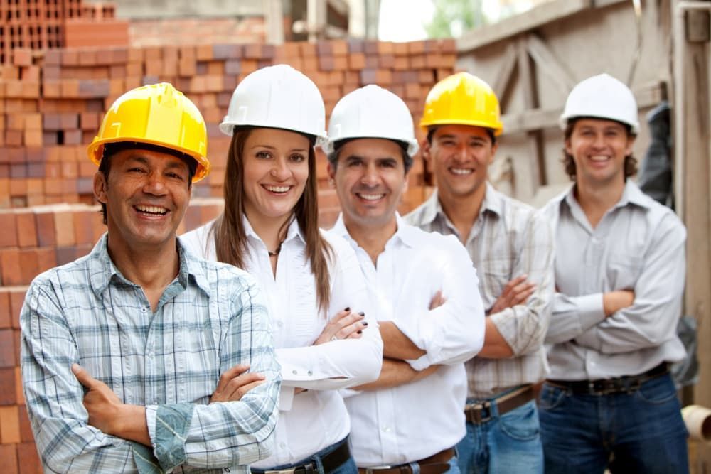 A Group of Construction Workers Wearing Hard Hats Are Posing for a Picture — Calibre Resourcing Solutions in Cairns, QLD
