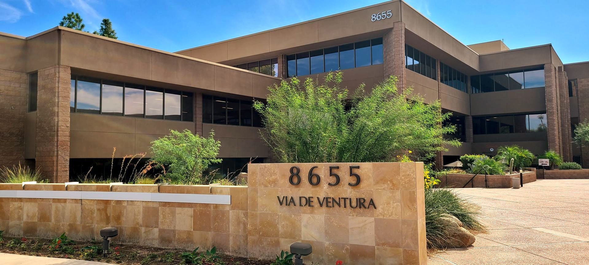 Office building exterior with sign reading 8655 Via De Ventura.