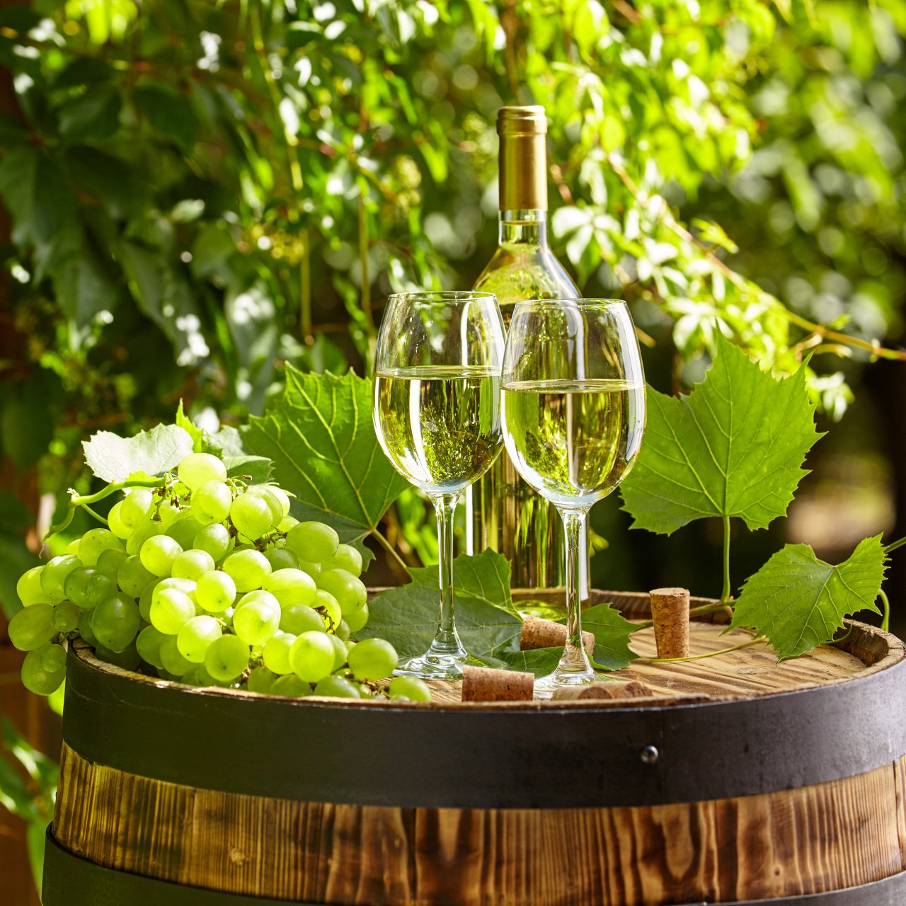 A barrel with a bottle of wine and two glasses on it