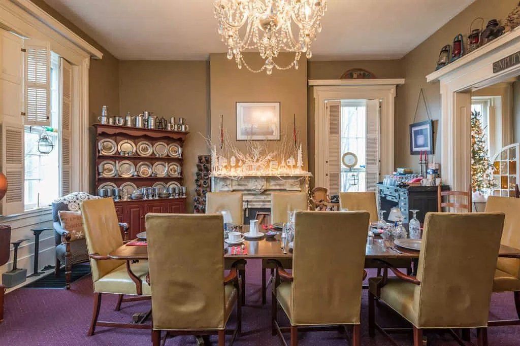 A large dining room with a table and chairs and a chandelier.
