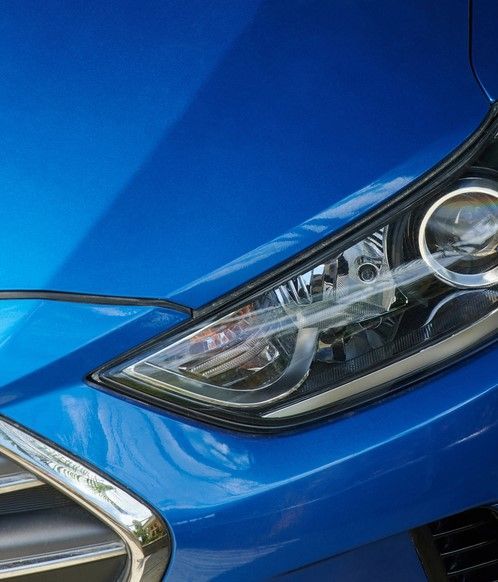 Car after detailing service, with polished paint, restored surfaces, and an overall pristine look.