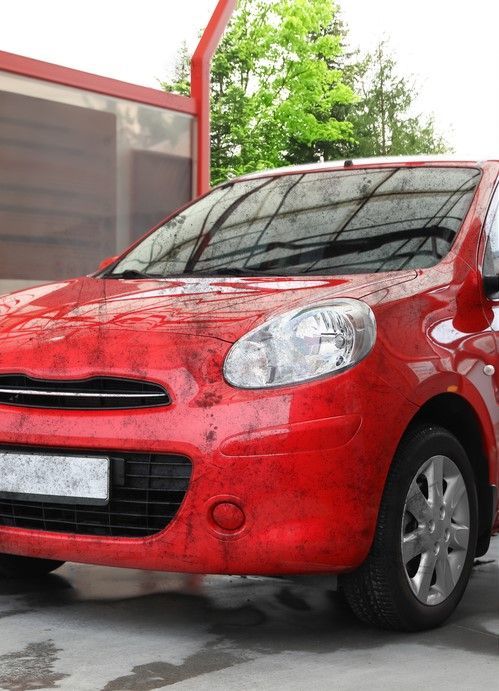 Car exterior before valet service, showing dirt and stains on the paintwork and wheels.