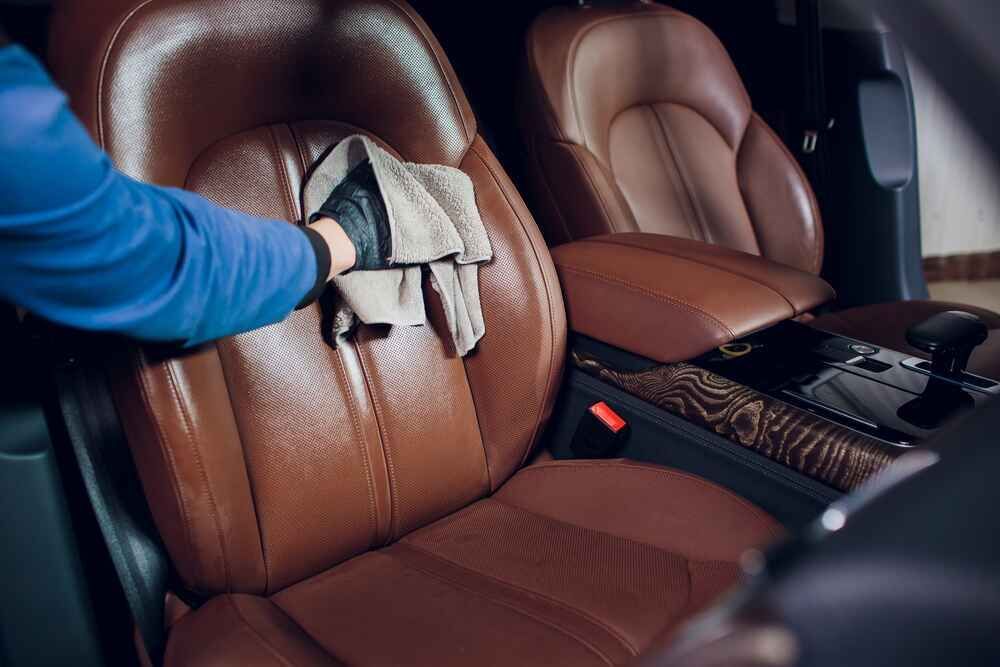 Picture showcasing a professional worker providing a full car valet