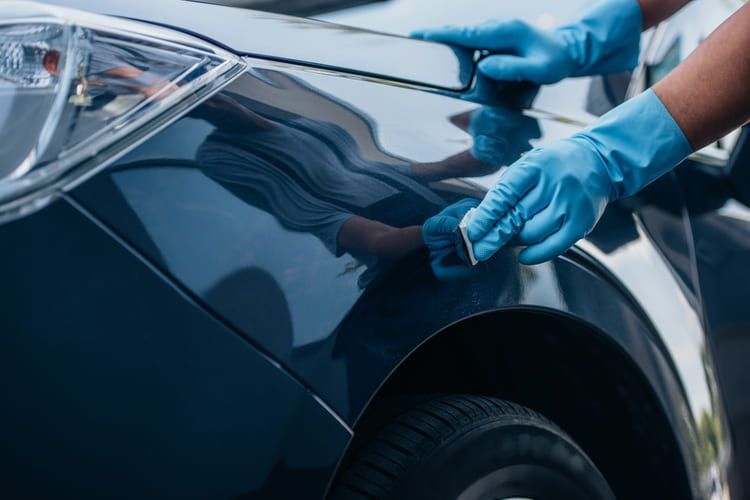 An image showing a professional car detailing service in action.