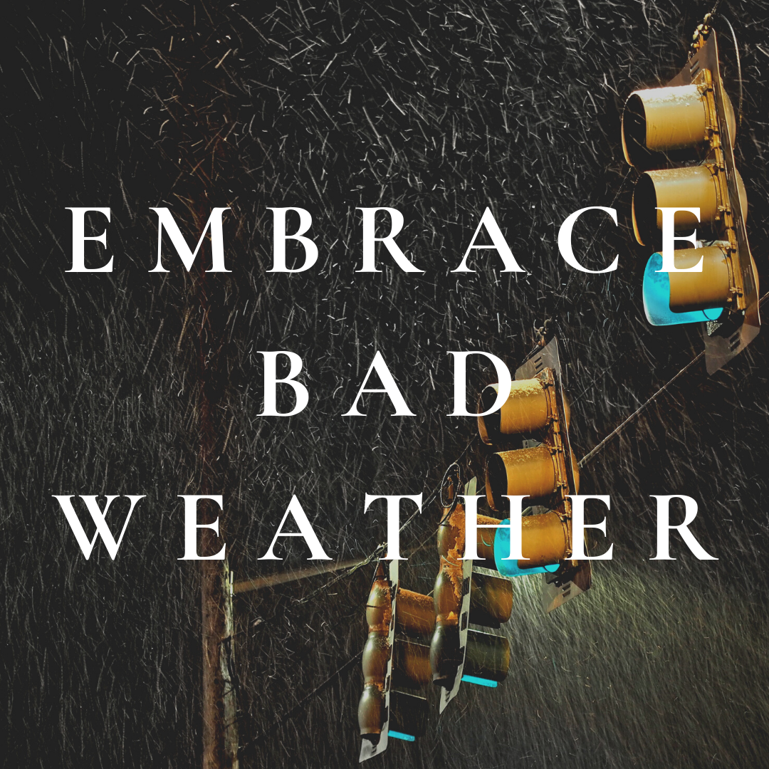 A sign that says ' embrace bad weather ' on it