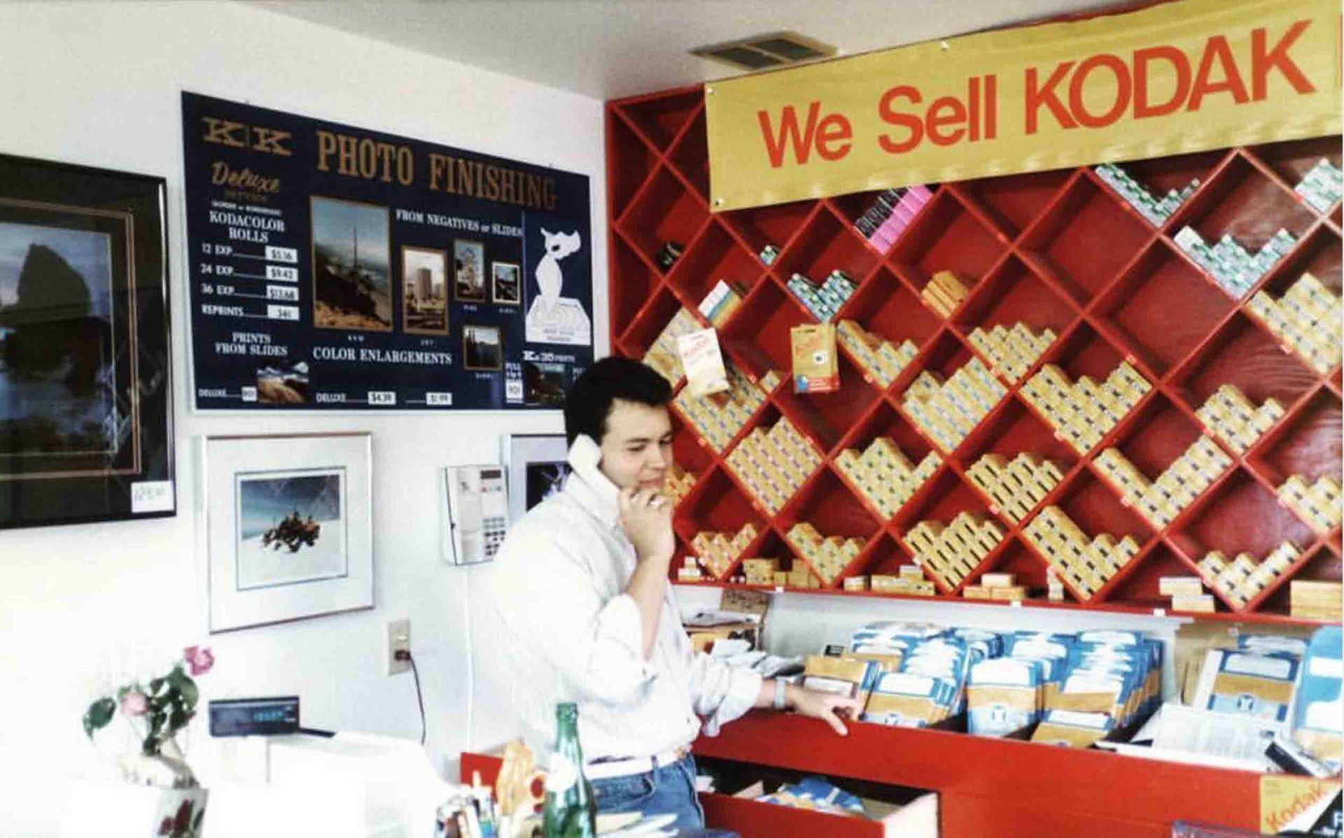 Original owner of Focal Point in 1983 stands in front of a shelf full of film