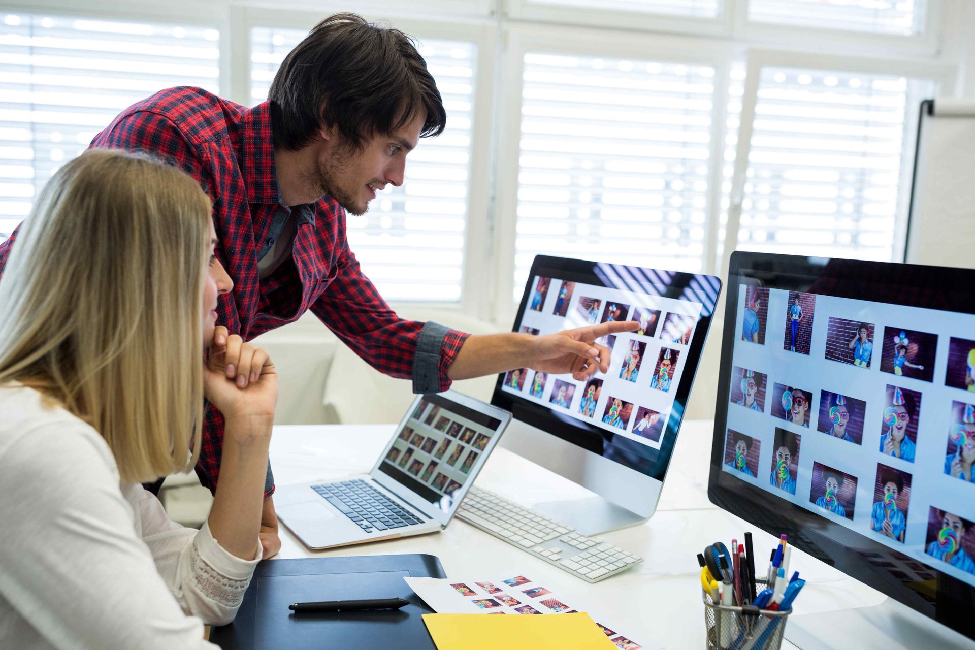 Two people working together on content & image management