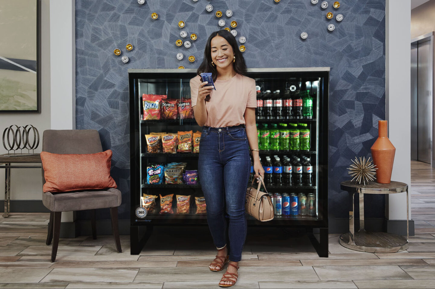 A woman is standing in front of a vending machine holding a cup of coffee.