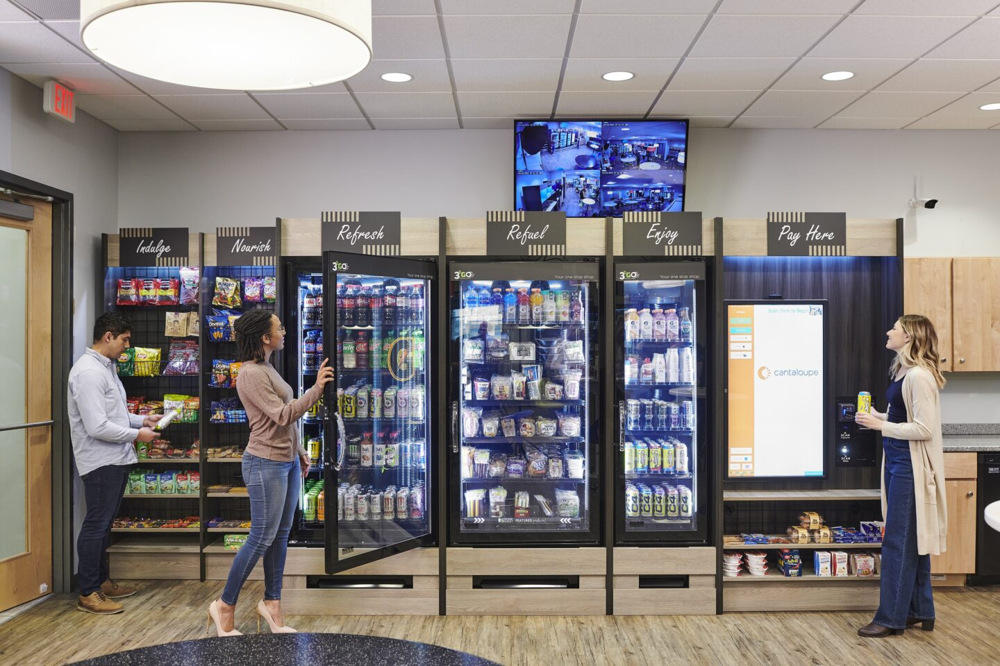 A man and a woman are standing in front of a vending machine.