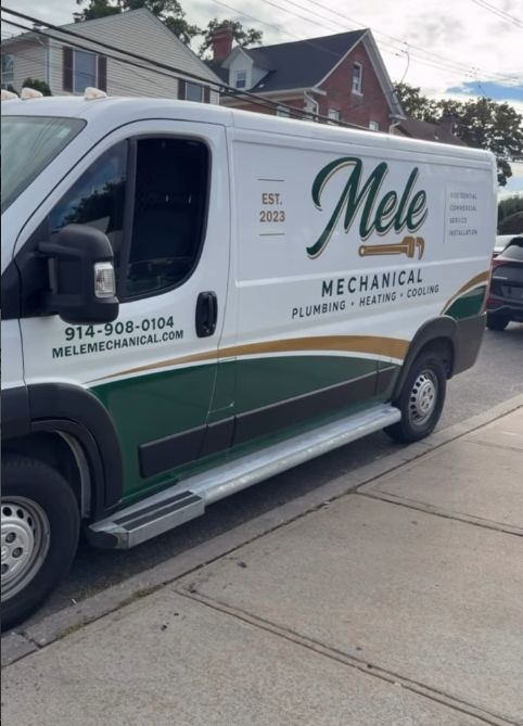 White and green Mele Mechanical plumbing van parked on a residential street.