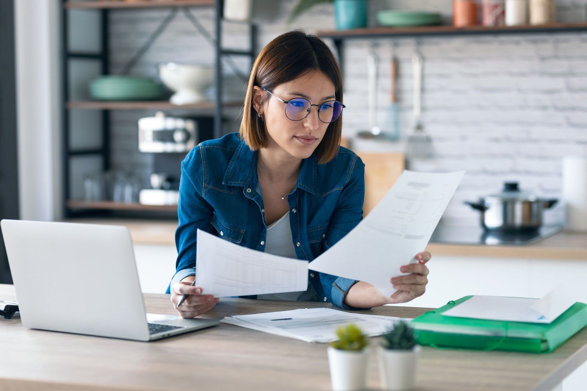Business owner spending precious time looking at paperwork and bills.