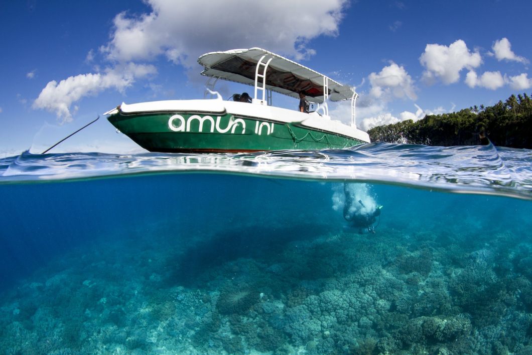 Split-view of  Amun ini speed boat floating on clear blue tropical water under a sunny sky